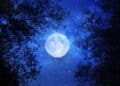 Surreal fantasy concept - full moon with stars glitter in night skies background